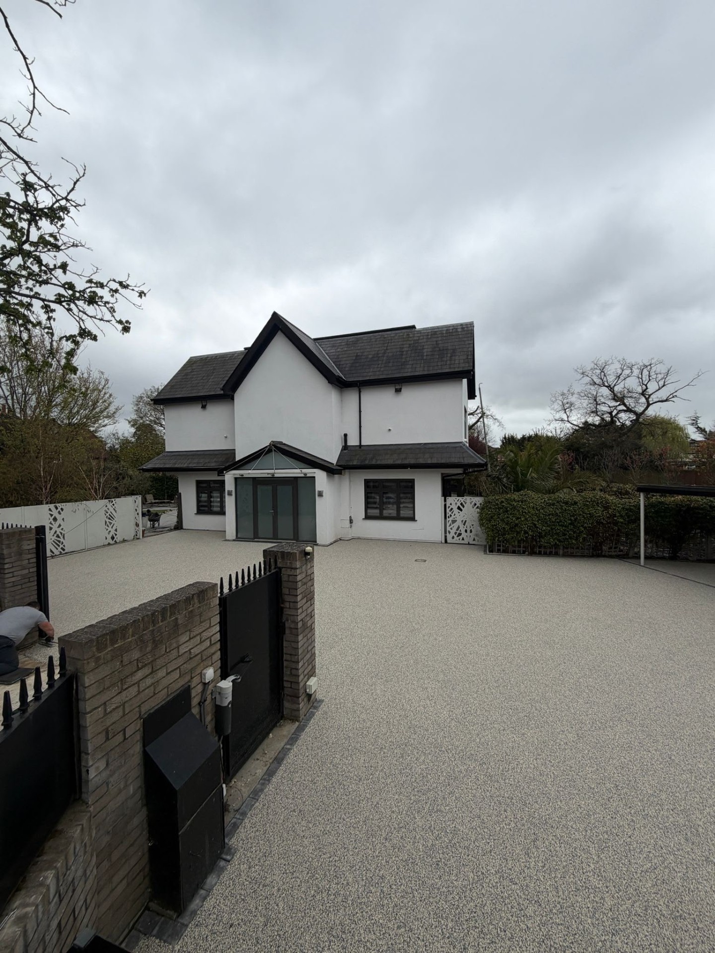 Silver resin bound driveway at a white detached family home