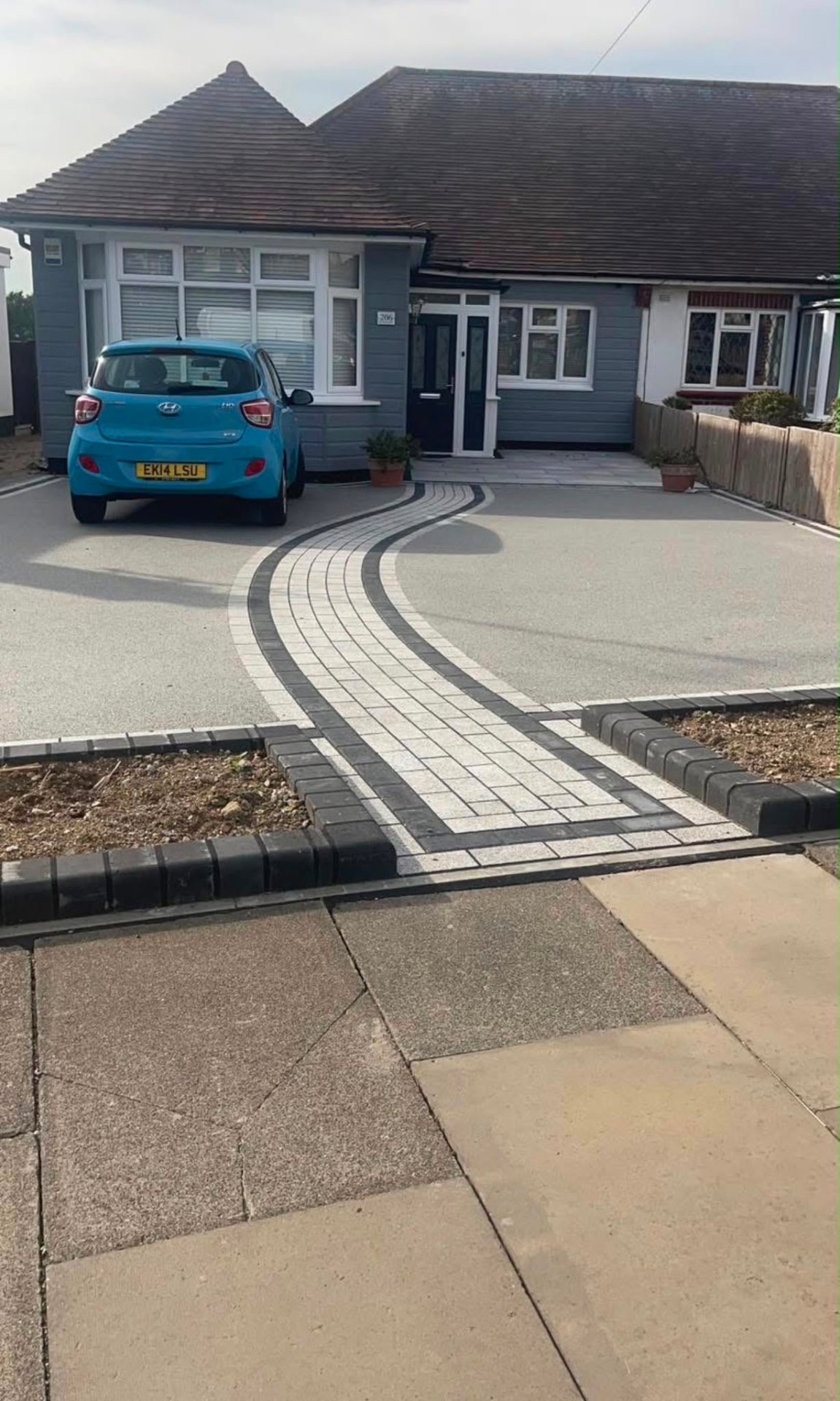Silver resin bound driveway with contrasting block paving detail