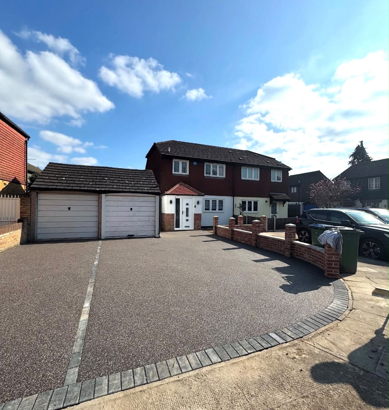 Silver resin bound driveway with block paving edge at a semi detached home