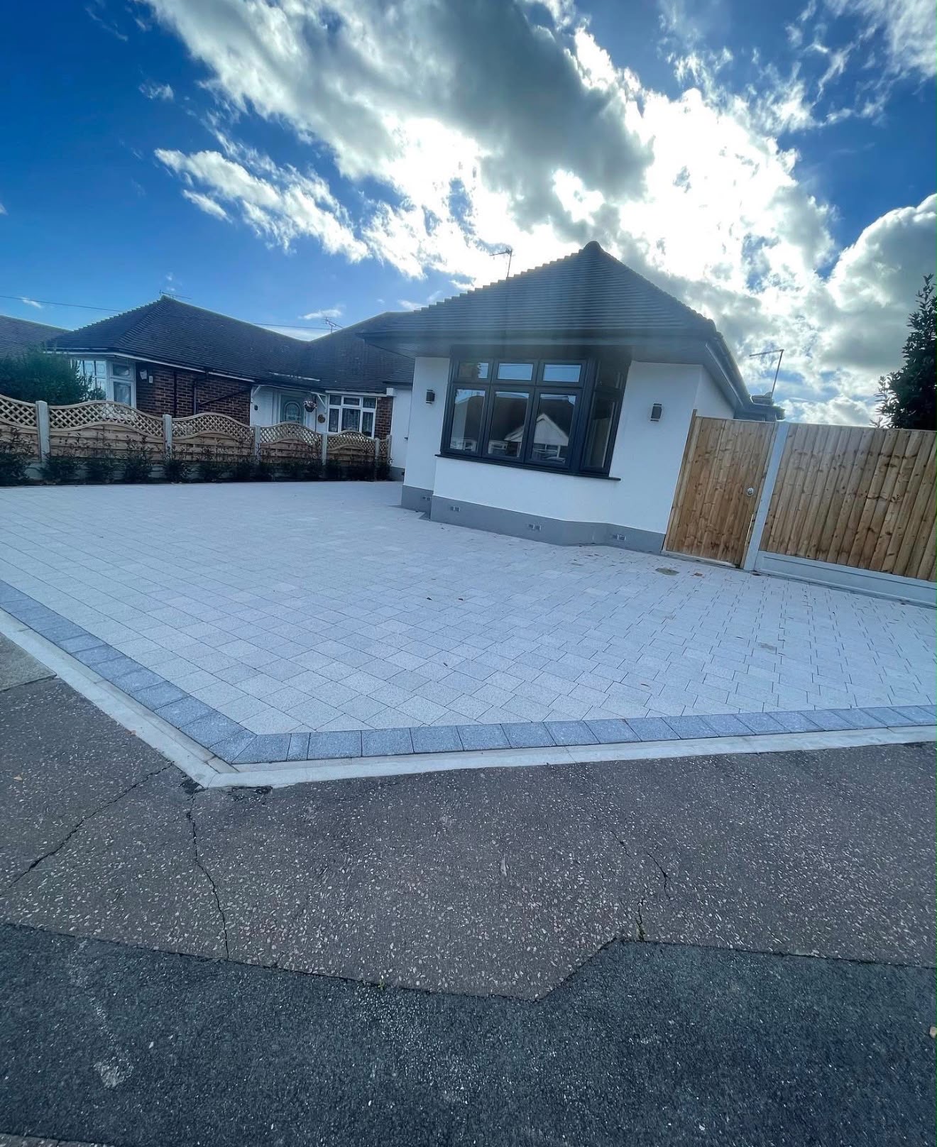 Silver granite paving driveway at a white rendered bungalow