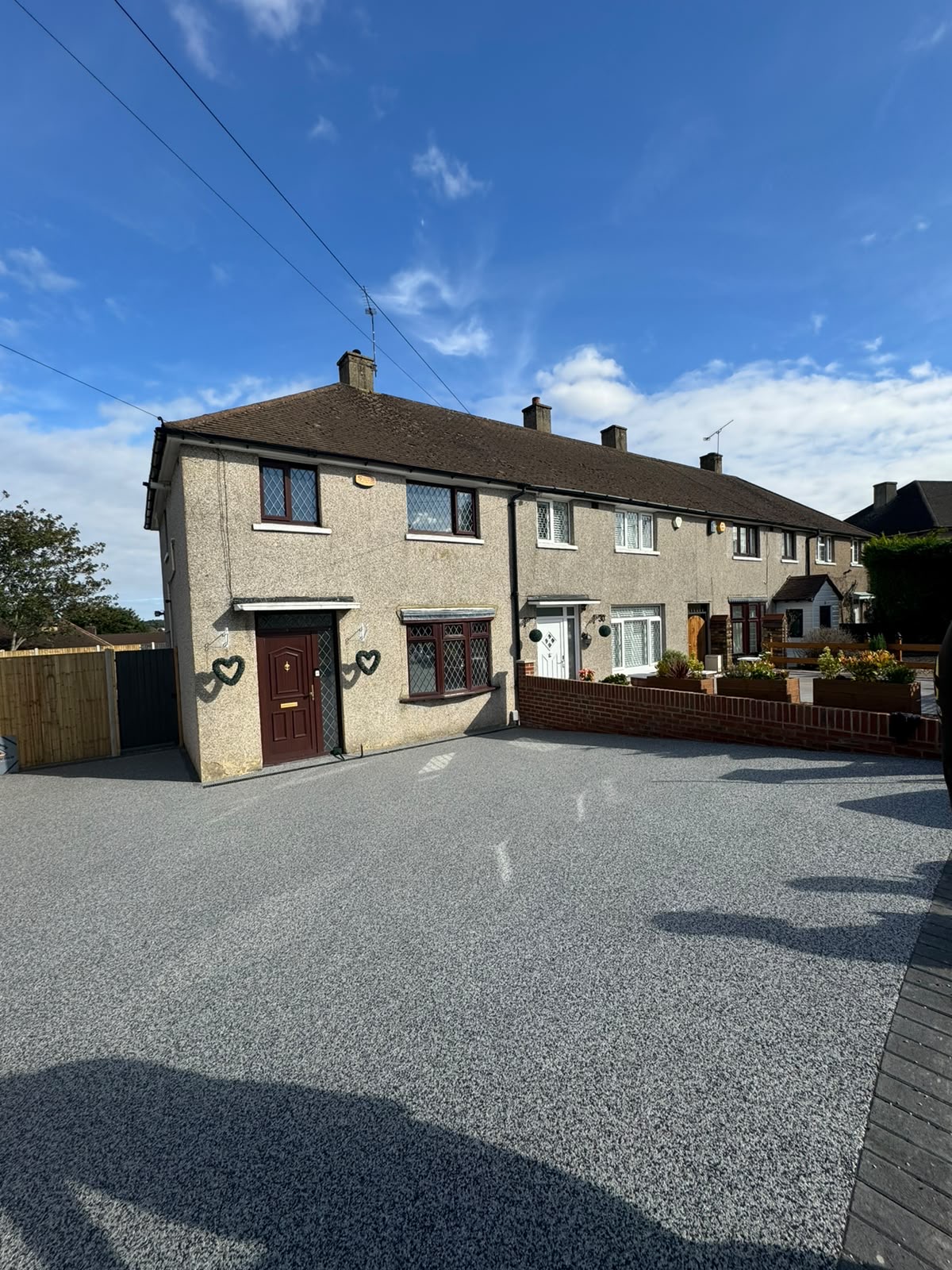 Light grey resin bound driveway at a semi detached home