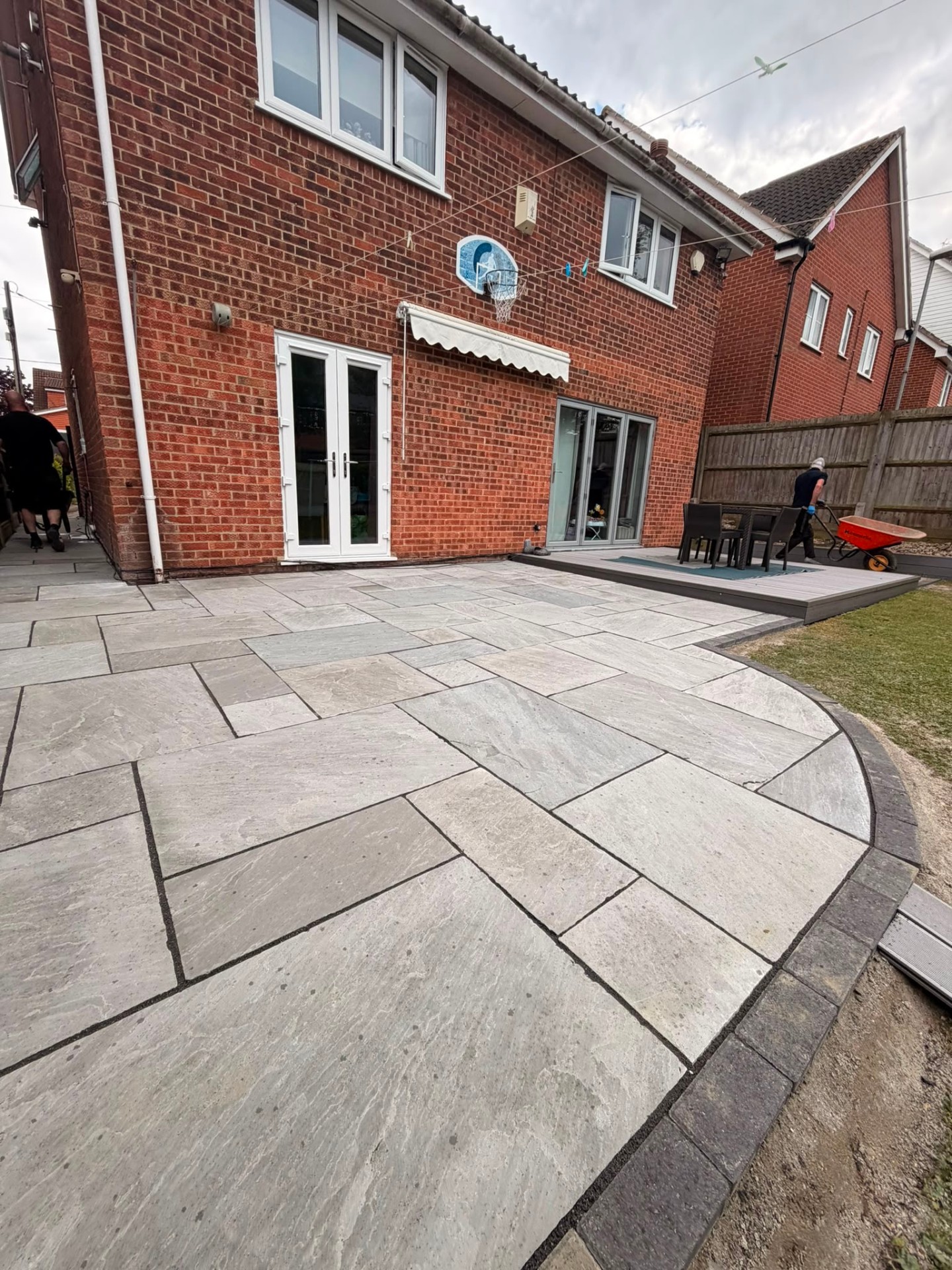 Indian sandstone patio laid in random pattern with charcoal border