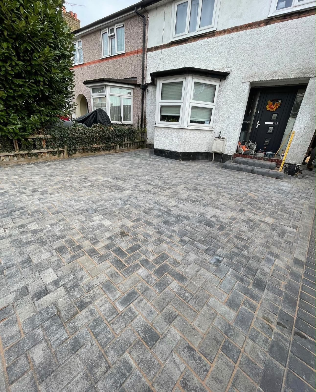 Charcoal herringbone block paving driveway at a terraced home