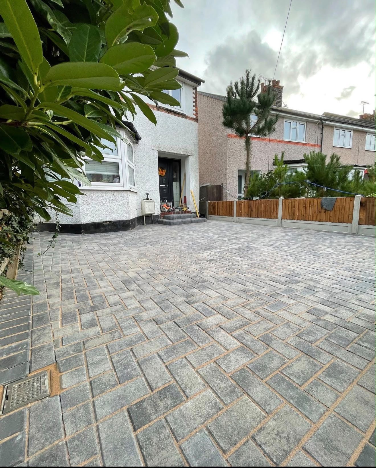 Charcoal block paving driveway at a rendered home