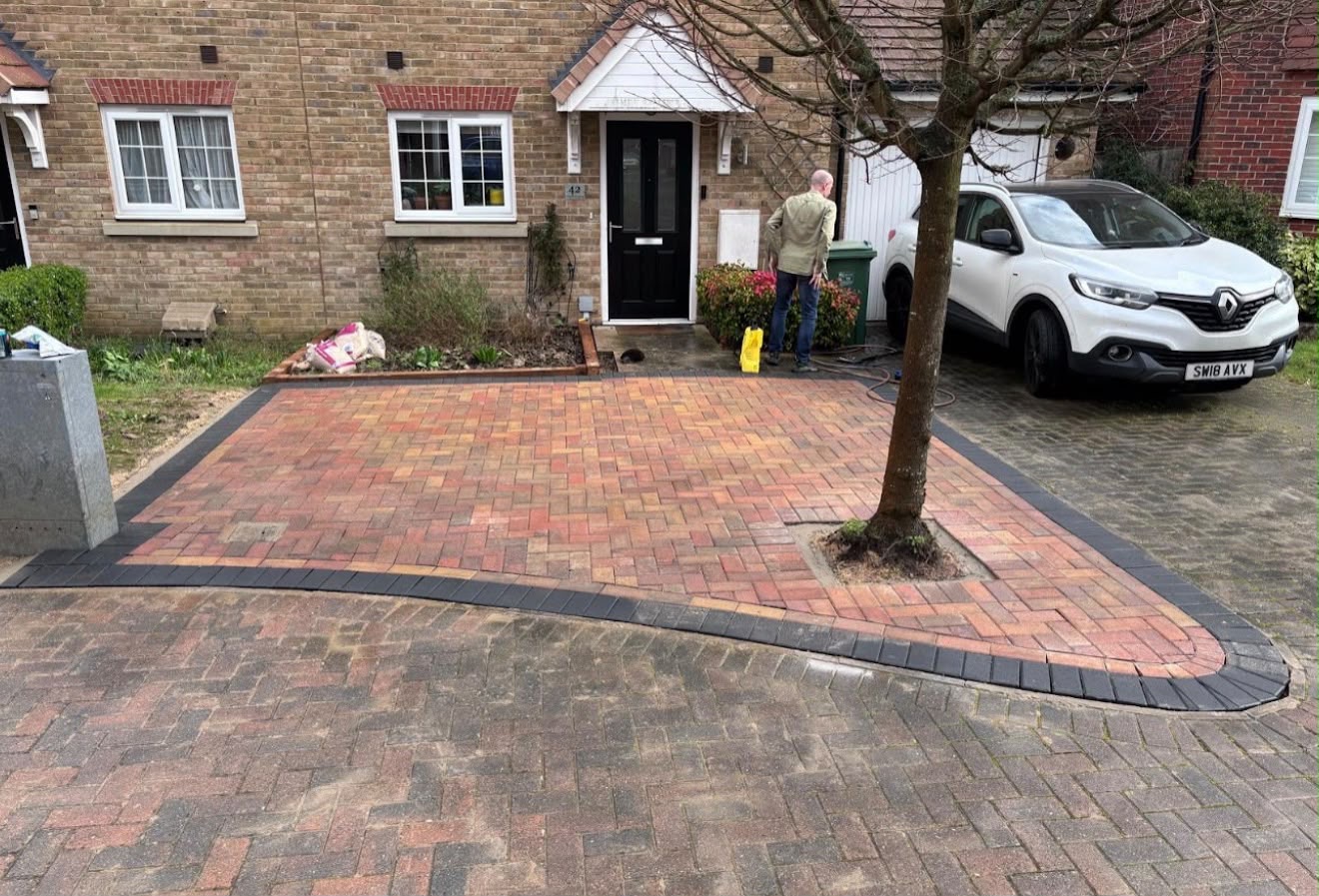 Brindle block paving driveway with charcoal border around a tree