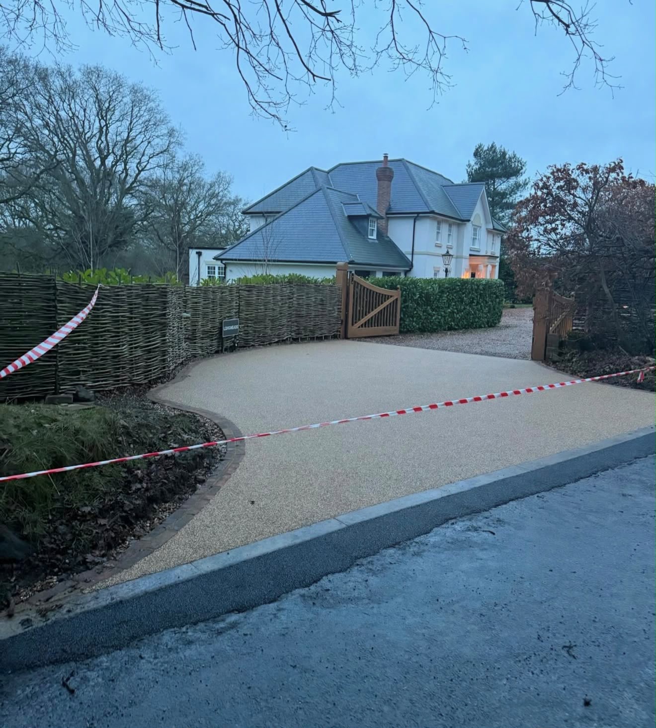 Gold resin bound driveway at a country home at dusk