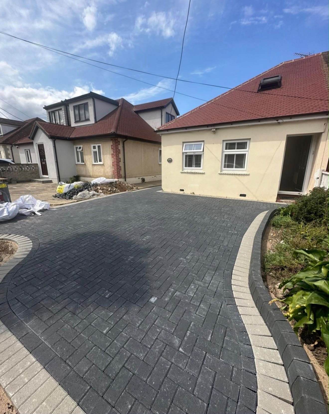 Charcoal block paving driveway with contrasting silver border